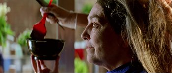 Movie still from “Volver” (2006), directed by Pedro Almodóvar – An older woman getting her hair cut at a barber shop; Close Up shot, Low angle