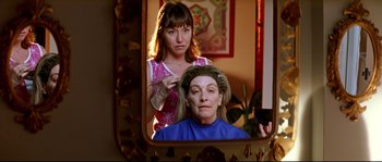 Movie still from “Volver” (2006), directed by Pedro Almodóvar – A woman sitting in front of an older woman in front of a mirror; Close Up shot, Over the shoulder angle