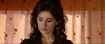 Movie still from “Volver” (2006), directed by Pedro Almodóvar – A person with long black hair; Close Up shot, High angle