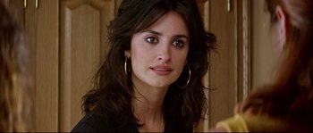 Movie still from “Volver” (2006), directed by Pedro Almodóvar – A person with long black hair; Close Up shot, Over the shoulder angle