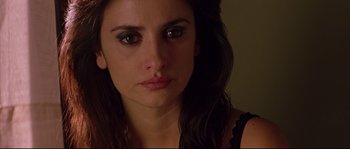 Movie still from “Volver” (2006), directed by Pedro Almodóvar – A woman's face in a dark room; Close Up shot, Over the shoulder angle