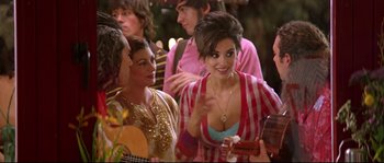 Movie still from “Volver” (2006), directed by Pedro Almodóvar – A group of people standing next to each other in a room; Medium shot, Over the shoulder angle