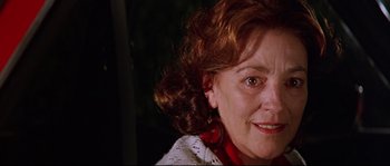 Movie still from “Volver” (2006), directed by Pedro Almodóvar – A woman's face in a dark room; Close Up shot, Low angle