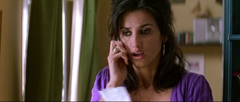 Movie still from “Volver” (2006), directed by Pedro Almodóvar – A person talking on a cell phone; Close Up shot, High angle