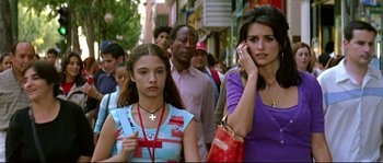 Movie still from “Volver” (2006), directed by Pedro Almodóvar – A group of people walking down a street; Close Up shot, High angle