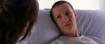Movie still from “Volver” (2006), directed by Pedro Almodóvar – A woman laying in a hospital bed looking sad; Close Up shot, Over the shoulder angle