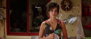 Movie still from “Volver” (2006), directed by Pedro Almodóvar – A woman in a floral dress holding a napkin; Close Up shot, Over the shoulder angle