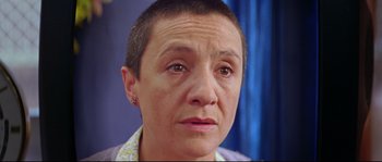 Movie still from “Volver” (2006), directed by Pedro Almodóvar – A person with short hair; Close Up shot, Low angle