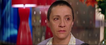 Movie still from “Volver” (2006), directed by Pedro Almodóvar – A person with short black hair; Close Up shot, High angle