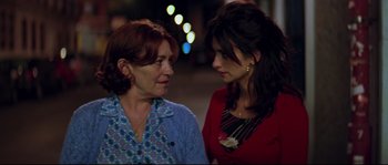 Movie still from “Volver” (2006), directed by Pedro Almodóvar – Two women standing next to each other on the street; Close Up shot, Over the shoulder angle