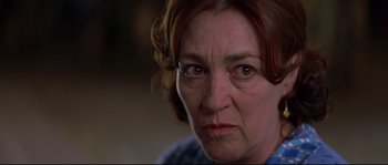 Movie still from “Volver” (2006), directed by Pedro Almodóvar – An older woman looking angry at the camera; Close Up shot, Low angle
