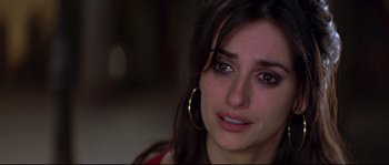 Movie still from “Volver” (2006), directed by Pedro Almodóvar – A person with a sad look on their face; Close Up shot, Over the shoulder angle