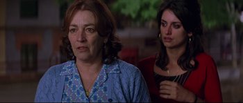 Movie still from “Volver” (2006), directed by Pedro Almodóvar – A woman and a woman sitting next to each other in a room; Close Up shot, Over the shoulder angle