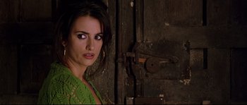 Movie still from “Volver” (2006), directed by Pedro Almodóvar – A woman in a green shirt is standing in front of a door; Close Up shot, Over the shoulder angle