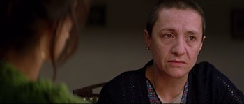 Movie still from “Volver” (2006), directed by Pedro Almodóvar – A woman sitting in front of another woman in a room; Close Up shot, Over the shoulder angle