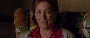 Movie still from “Volver” (2006), directed by Pedro Almodóvar – A person wearing a red scarf; Close Up shot, Low angle