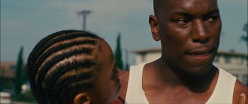 Movie still from “Waist Deep” (2006), directed by Vondie Curtis-Hall – A young man and a little girl looking into each other's eyes; Close Up shot, Over the shoulder angle