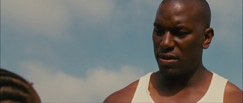 Movie still from “Waist Deep” (2006), directed by Vondie Curtis-Hall – A person wearing a white shirt; Close Up shot, Low angle