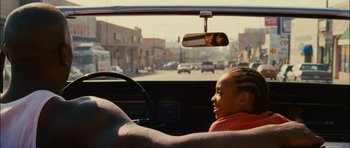 Movie still from “Waist Deep” (2006), directed by Vondie Curtis-Hall – A young girl sitting in the driver's seat of a car; Close Up shot, Over the shoulder angle