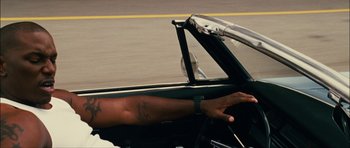 Movie still from “Waist Deep” (2006), directed by Vondie Curtis-Hall – A man driving a car on the street; Close Up shot, High angle