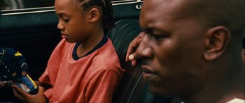 Movie still from “Waist Deep” (2006), directed by Vondie Curtis-Hall – A man and a child sitting on a bus; Close Up shot, Over the shoulder angle