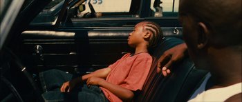 Movie still from “Waist Deep” (2006), directed by Vondie Curtis-Hall – A young boy sitting in the back seat of a car; Close Up shot, High angle