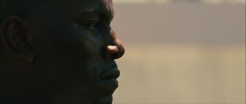 Movie still from “Waist Deep” (2006), directed by Vondie Curtis-Hall – A man's face in the sunlight; Close Up shot, Low angle