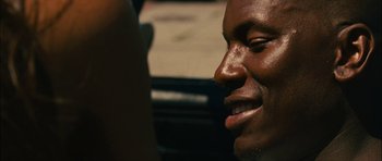 Movie still from “Waist Deep” (2006), directed by Vondie Curtis-Hall – A man's face with his mouth open; Close Up shot, Over the shoulder angle