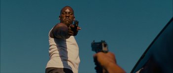 Movie still from “Waist Deep” (2006), directed by Vondie Curtis-Hall – A man is pointing a gun at another man's face; Close Up shot, Low angle