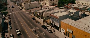 Movie still from “Waist Deep” (2006), directed by Vondie Curtis-Hall – An aerial view of a street with cars parked on the side of the road; Extreme Wide shot, High angle
