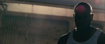 Movie still from “Waist Deep” (2006), directed by Vondie Curtis-Hall – A man standing next to a window in a room; Close Up shot, Low angle