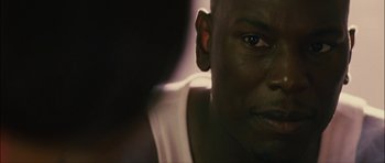 Movie still from “Waist Deep” (2006), directed by Vondie Curtis-Hall – A person's face in a dark room; Close Up shot, Over the shoulder angle