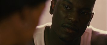 Movie still from “Waist Deep” (2006), directed by Vondie Curtis-Hall – A man's face in a dark room; Close Up shot, Over the shoulder angle