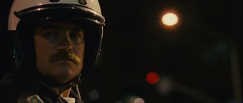 Movie still from “Waist Deep” (2006), directed by Vondie Curtis-Hall – A man in a police uniform with a mustache; Close Up shot, Low angle