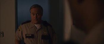 Movie still from “Waist Deep” (2006), directed by Vondie Curtis-Hall – A man in a police uniform looking at the camera; Close Up shot, Over the shoulder angle