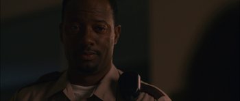 Movie still from “Waist Deep” (2006), directed by Vondie Curtis-Hall – A man in a police uniform is looking at the camera; Close Up shot, Low angle