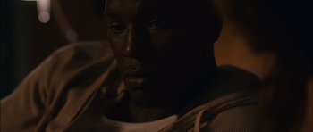 Movie still from “Waist Deep” (2006), directed by Vondie Curtis-Hall – A man's face in the dark; Close Up shot, High angle