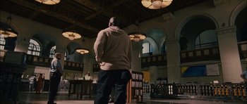 Movie still from “Waist Deep” (2006), directed by Vondie Curtis-Hall – A man standing in a room with his back to the camera; Wide shot, Low angle