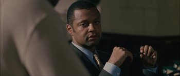 Movie still from “Waist Deep” (2006), directed by Vondie Curtis-Hall – A man in a suit and a tie; Close Up shot, Over the shoulder angle