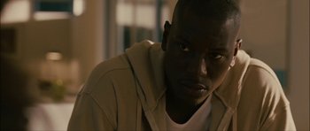Movie still from “Waist Deep” (2006), directed by Vondie Curtis-Hall – A person wearing a hooded jacket; Close Up shot, Over the shoulder angle