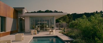 Movie still from “Waist Deep” (2006), directed by Vondie Curtis-Hall – A modern house with a swimming pool in front of it; Extreme Wide shot, Low angle