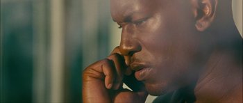Movie still from “Waist Deep” (2006), directed by Vondie Curtis-Hall – A man's face with his chin resting on his hand; Close Up shot, Low angle
