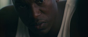 Movie still from “Waist Deep” (2006), directed by Vondie Curtis-Hall – A person's face in a dark room; Extreme Close Up shot, Low angle