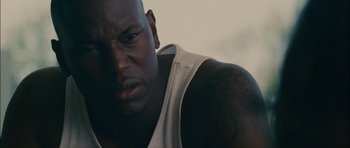 Movie still from “Waist Deep” (2006), directed by Vondie Curtis-Hall – A person with a tattoo on his arm; Close Up shot, High angle