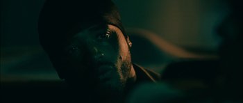 Movie still from “Waist Deep” (2006), directed by Vondie Curtis-Hall – A man's face in the dark; Close Up shot, Over the shoulder angle