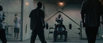 Movie still from “Waist Deep” (2006), directed by Vondie Curtis-Hall – A group of people in a gym with barbells; Wide shot, Over the shoulder angle