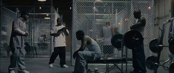 Movie still from “Waist Deep” (2006), directed by Vondie Curtis-Hall – A group of men standing next to each other in a room; Wide shot, High angle