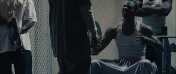 Movie still from “Waist Deep” (2006), directed by Vondie Curtis-Hall – Two men holding hands in a dark room; Medium shot, Over the shoulder angle