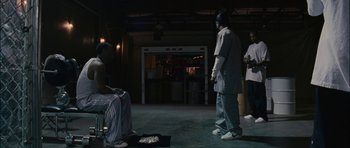 Movie still from “Waist Deep” (2006), directed by Vondie Curtis-Hall – A group of people standing in a dark room; Wide shot, Over the shoulder angle