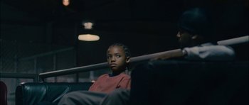 Movie still from “Waist Deep” (2006), directed by Vondie Curtis-Hall – A young boy sitting in a chair in a dark room; Close Up shot, Low angle